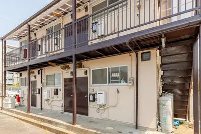 a building with a balcony on the side of it at tkm\u5317\u5c0f\u5ca91\u4e01\u76ee202 in Tokyo