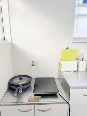 a laptop sitting on a counter in a kitchen at tkm\u5317\u5c0f\u5ca91\u4e01\u76ee203 in Tokyo