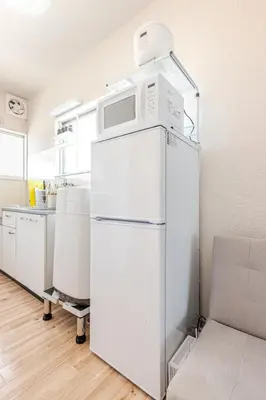 a white refrigerator with a microwave on top of it at tkm\u5317\u5c0f\u5ca91\u4e01\u76ee203 in Tokyo