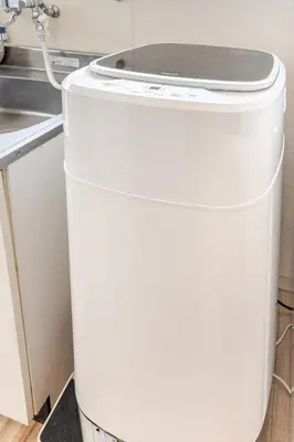 a white trash can in a kitchen next to a sink at tkm\u5317\u5c0f\u5ca91\u4e01\u76ee203 in Tokyo