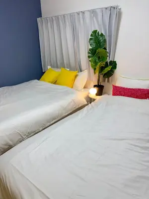 two beds sitting next to each other in a room at Style Lab\u56db\u3064\u6728 in Tokyo