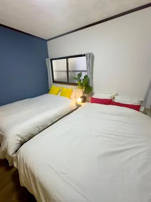 two beds sitting next to each other in a bedroom at Style Lab\u56db\u3064\u6728 in Tokyo