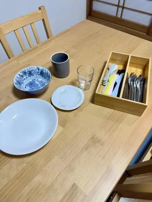 a wooden table with plates and utensils on it at Style Lab\u56db\u3064\u6728 in Tokyo