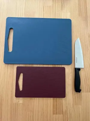 a blue cutting board with a knife on a table at Style Lab\u56db\u3064\u6728 in Tokyo