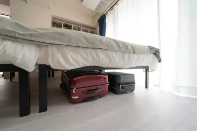 two pieces of luggage sitting under a bed at 8Minutes Walk to IkebukuroStation, CentralTokyo and VeryConvenient Max5People in Tokyo