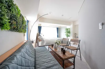 a living room with a couch and a table at 8Minutes Walk to IkebukuroStation, CentralTokyo and VeryConvenient Max5People in Tokyo
