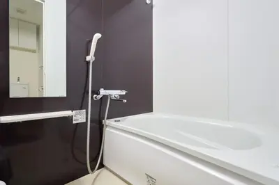 a bathroom with a white tub and a mirror at N 5min to waseda sta designer condo high security free wifi in Tokyo
