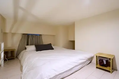 a bedroom with a large white bed and a table at N 5min to waseda sta designer condo high security free wifi in Tokyo