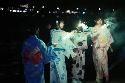 a group of women in kimonos holding fireworks at Beauty House in Tokyo