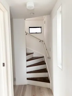 a staircase in a home with white walls and wooden floors at Beauty House in Tokyo