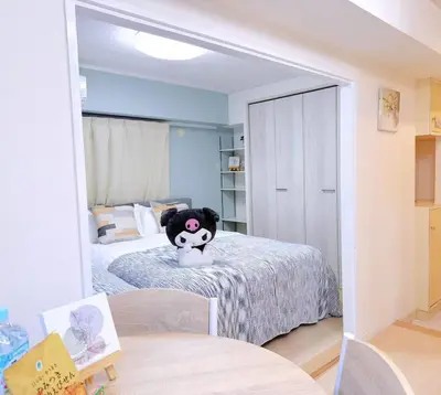 a bedroom with a stuffed animal sitting on a bed at Minato Residence-Tokyo Tower-Daimon in Tokyo