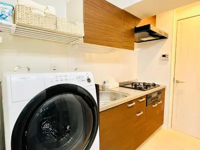 a washing machine in a kitchen next to a sink at Minato Residence-Tokyo Tower-Daimon in Tokyo