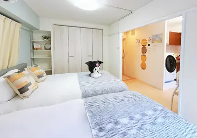 a bedroom with two beds with a stuffed animal sitting on it at Minato Residence-Tokyo Tower-Daimon in Tokyo