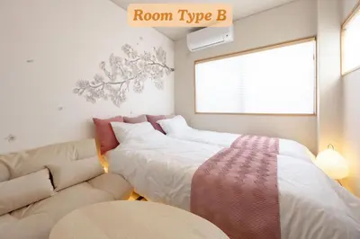 a room with two beds and a couch at Sakura Hotel Koiwa in Tokyo