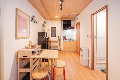 a kitchen with a table and chairs in a room at 2 min walking distance to station cozy room in central tokyo in Tokyo