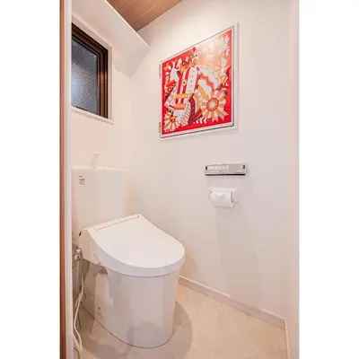 a bathroom with a toilet and a painting on the wall at 2 min walking distance to station cozy room in central tokyo in Tokyo