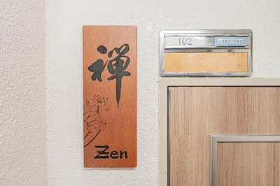 a sign on a wall next to a door at 2 min walking distance to station cozy room in central tokyo in Tokyo