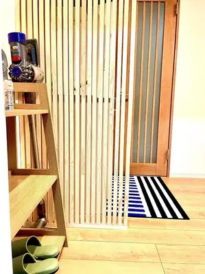 a wooden gate with a black and white rug in a room at 2 min walking distance to station cozy room in central tokyo in Tokyo