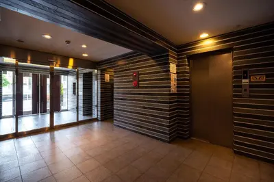 an empty lobby with a wall of wood at \u30e6\u30ca\u30a4\u30c6\u30c3\u30c9\u30b0\u30ed\u30fc\u7530\u7aef\u65b0\u753a in Tokyo