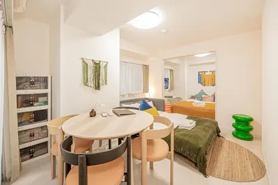 a living room with a table and a bedroom at Mi-HOTEL UENO IRIYA in Tokyo