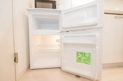 a white refrigerator with its door open in a kitchen at Mi-HOTEL UENO IRIYA in Tokyo