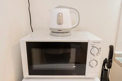 a white mixer sitting on top of a microwave at Mi-HOTEL UENO IRIYA in Tokyo