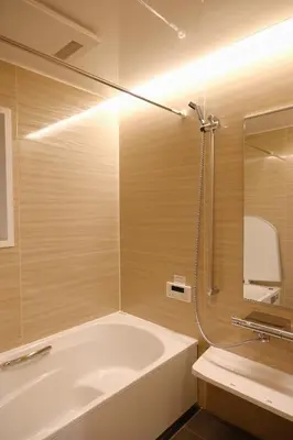 a bathroom with a tub and a shower and a sink at Mi-Villa Aprire Yotsuya in Tokyo