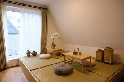 a living room with two tables and a window at Mi-Villa Aprire Yotsuya in Tokyo