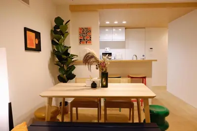 a kitchen with a table with a vase of flowers on it at Mi-Villa Aprire Yotsuya in Tokyo