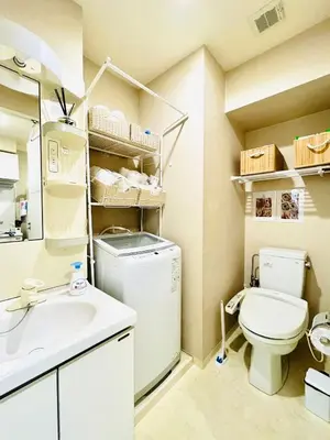 a bathroom with a washer and dryer and a sink at \u9326\u7cf8\u753a-502 in Tokyo