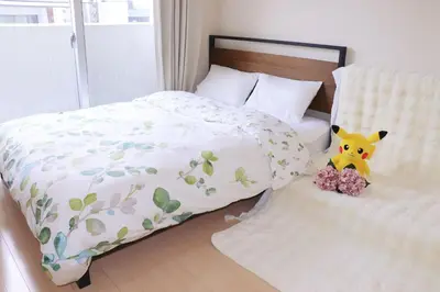 a bed with a stuffed animal sitting on it at \u9326\u7cf8\u753a-502 in Tokyo