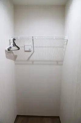 a white closet with a glass shelf on a wall at Km101 \u4e0a\u6c60\u888b in Tokyo
