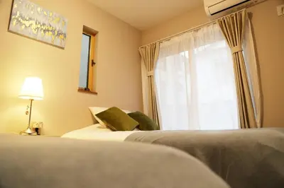 a hotel room with two beds and a window at Km102\u4e0a\u6c60\u888b in Tokyo
