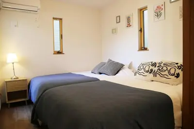 a bedroom with two beds and a night stand with a lamp at Km201\u4e0a\u6c60\u888b in Tokyo