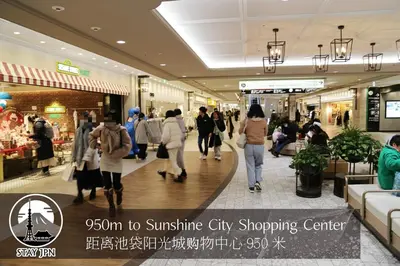 a group of people walking in a shopping center at Km201\u4e0a\u6c60\u888b in Tokyo