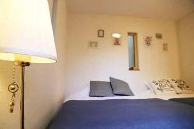 a bedroom with a bed with a lamp and a bed sidx sidx sidx at Km201\u4e0a\u6c60\u888b in Tokyo