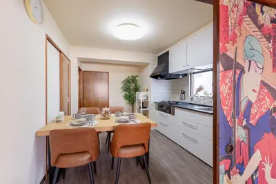 a kitchen and dining room with a wooden table and chairs at o\u30d3\u30eb301 in Tokyo