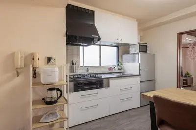 a kitchen with a stove and a refrigerator at o\u30d3\u30eb301 in Tokyo