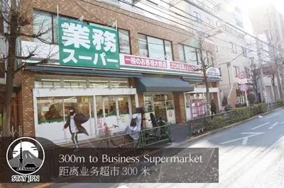 a building with a sign on the side of a street at Km202\u4e0a\u6c60\u888b in Tokyo