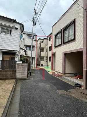an empty street in a city with buildings at Km202\u4e0a\u6c60\u888b in Tokyo