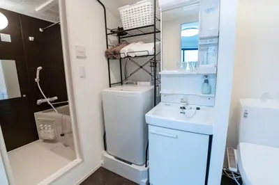 a small bathroom with a toilet and a sink at 5 min walk from Gotanno station 20sqm apartment with private toilet and bathroom Direct access to popular travel destinations such as Ueno in Tokyo