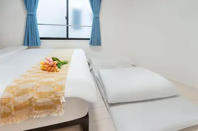 a white bench with a flower arrangement on it at 5 min walk from Gotanno station 20sqm apartment with private toilet and bathroom Direct access to popular travel destinations such as Ueno in Tokyo