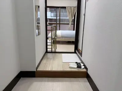 a hallway with a mirror and a room with a bed at SkyTree-402 in Tokyo