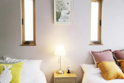 a bedroom with two beds and a lamp and two windows at Km302\u4e0a\u6c60\u888b in Tokyo