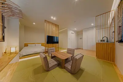 a bedroom with a bed and a table and chairs at Hotel Shitamachi Place Asakusa in Tokyo