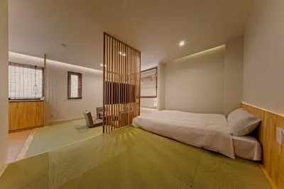 a bedroom with a large white bed in it at Hotel Shitamachi Place Asakusa in Tokyo