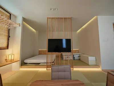 a living room with a tv and a bedroom at Hotel Shitamachi Place Asakusa in Tokyo