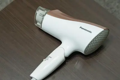 a white electric toothbrush sitting on a wooden table at APA SERVICED RESIDENCE SHINJUKU by unito in Tokyo