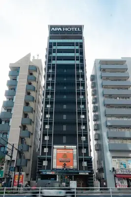 a building with a sign on the side of it at APA SERVICED RESIDENCE SHINJUKU by unito in Tokyo