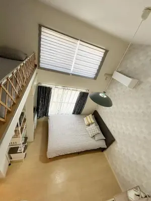 a living room with a couch and a stair case at Shinjuku\u5927\u4e45\u4fdd\u97e9\u56fd\u6b65\u884c\u8857#JR\u65b0\u5927\u4e45\u4fdd\u7ad9\u6b65\u884c4\u5206\u949f#\u8dc3\u5c42loft\u7684\u7cbe\u81f4\u516c\u5bd3#\u9ad8\u901f\u65e0\u9650\u5236\u7f51\u7edc#B201 in Tokyo